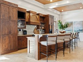 Warner Robins apartment for rent - A kitchen with wooden cabinets and a stone countertop.
