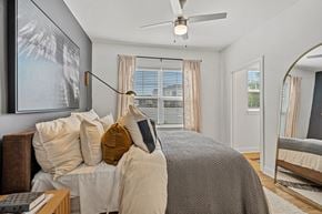Holly Springs apartment for rent - A bedroom with a large bed and a ceiling fan.