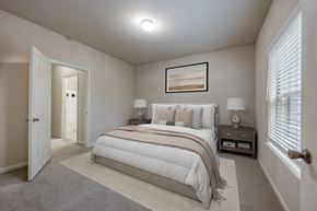 Kennesaw apartment for rent - A bedroom with a large bed and a painting on the wall.