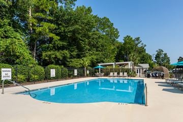 Wilmington apartment for rent - A pool surrounded by trees and a warning sign.