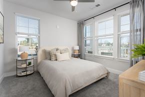 New Bern apartment for rent - A bedroom with a large bed and a ceiling fan.
