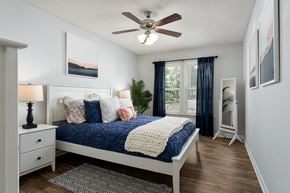 Wilmington apartment for rent - A bedroom with a bed, nightstand, and a ceiling fan.