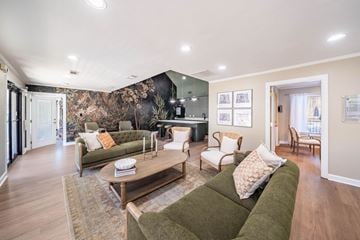 Hoover apartment for rent - A living room with a green couch and a coffee table.