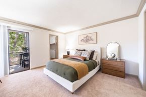 Hoover apartment for rent - A bedroom with a large bed and a sliding glass door.
