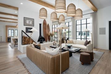 Ocean Isle Beach apartment for rent - A living room with a white couch and a fireplace.