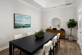 New Bern apartment for rent - A dining room with a black table and white chairs.
