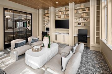 Fort Myers apartment for rent - A modern living room with a white sofa set and a wooden bookshelf.