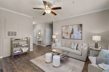 Greensboro apartment for rent - A living room with a white ceiling fan and a painting on the wall.