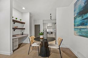 Wake Forest apartment for rent - A modern kitchen with a dining table set for two.