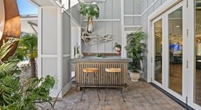 Myrtle Beach apartment for rent - A modern outdoor kitchen area with a wooden counter and a bar stool.
