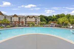 Macon apartment for rent - A large swimming pool in front of apartment buildings.