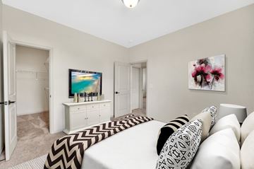 Pineville apartment for rent - A living room with a white couch and a television on a white cabinet.