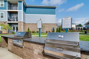 Whitsett apartment for rent - A wall of grills is in front of a building.