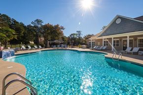 Spring Lake apartment for rent - A large swimming pool with a sunny sky above.