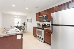 Fayetteville apartment for rent - A kitchen with a stainless steel refrigerator, microwave, oven, and sink.