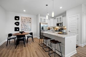 Wake Forest apartment for rent - a kitchen with a large island with a breakfast bar and stools