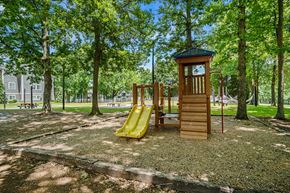 Greensboro apartment for rent - a playground with a wooden tower with a clock on it