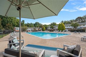 Winston Salem apartment for rent - a swimming pool with chairs and an umbrella at a resort