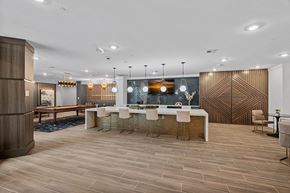 Cary apartment for rent - A modern dining room with a wooden table and chairs.