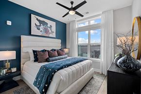 Cary apartment for rent - A bedroom with a large bed and a ceiling fan.