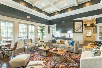 Huntsville apartment for rent - A living room with a large rug and a variety of seating options.