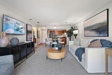 Schaumburg apartment for rent - A living room with a grey carpet and a white sofa.