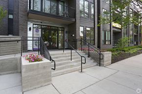 Evanston apartment for rent - A building with a glass door and a staircase with a railing.