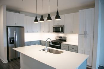 A kitchen with white counter tops and white cabinets