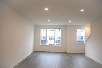 A living room with wood floors and a large window