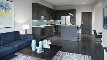 Wilmette apartment for rent - A modern living room with a dark blue sofa and a coffee table with decorative objects on it.
