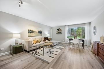 Palatine apartment for rent - A living room with a white couch and a painting on the wall.