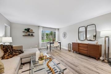 Palatine apartment for rent - A modern living room with a glass coffee table and a grey sofa.