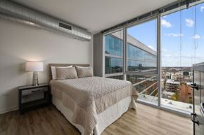 Chicago apartment for rent - a bedroom with a large bed and a large window at Halsted Flats Apartments, Chicago, Illinois