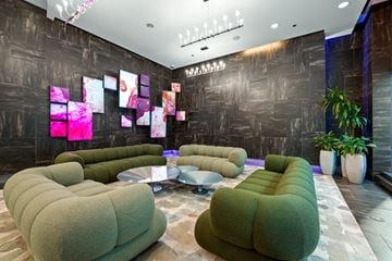 Chicago apartment for rent - A modern living room with a grey sofa and a glass table.