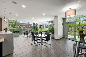 Chicago apartment for rent - a seating area with a table and chairs in the atrium of a building at Halsted Flats Apartments, Chicago, Illinois