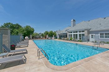 Outdoor heated pool with sundeck and lounge furniture