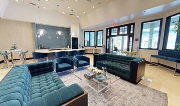 Oakbrook Terrace apartment for rent - A living room with a large green couch and a glass coffee table.