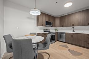 Deerfield apartment for rent - A modern kitchen with a dining table and chairs.