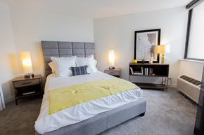 Chicago apartment for rent - a bedroom with a bed and a large window at The Kent, Chicago, IL, 60614