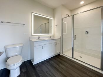 A bathroom with a toilet sink and a shower