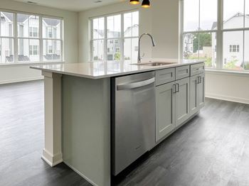 A large kitchen with a large island and a sink in it