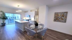Crystal Lake townhouse for rent - a kitchen and dining area with a glass table and chairs