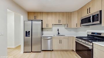 Libertyville apartment for rent - A kitchen with wooden cabinets and stainless steel appliances.