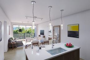 Evanston apartment for rent - A modern kitchen with a large island and a view of the outdoors.