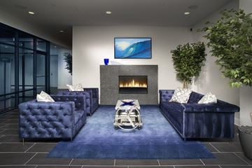 Evanston apartment for rent - A living room with a blue couch and a television on the wall.