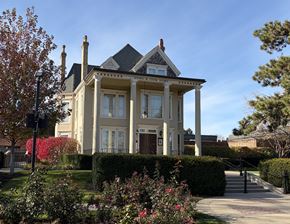 Libertyville apartment for rent - A large, well-maintained house with a garden in front.