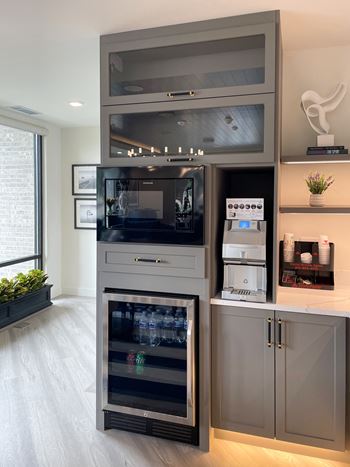 A kitchen with a cabinet with a refrigerator and a microwave