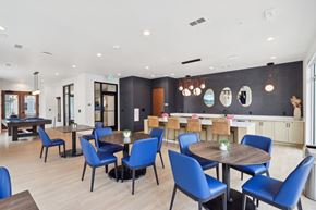 Wauwatosa apartment for rent - A modern dining room with blue chairs and wooden tables at 2929 on Mayfair, Wauwatosa, 53222