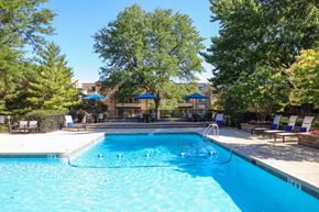 Schaumburg apartment for rent - a swimming pool with trees and chairs around it at Fieldpointe of Schaumburg, Schaumburg, 60173