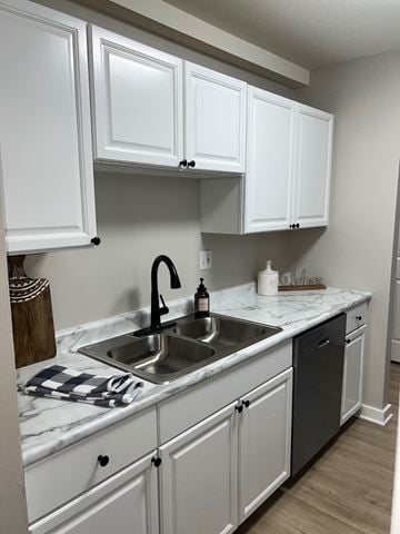 Schaumburg apartment for rent - A kitchen with white cabinets and a marble countertop.